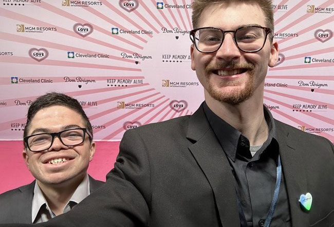 Caregivers Kyle Underwood (left) and Adam Haas (right) take a smiling photo together at a conference.