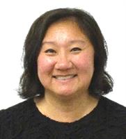 Smiling woman with short dark hair wearing a black top.