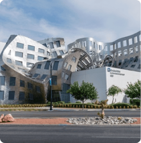 The Cleveland Clinic Lou Ruvo Center for Brain Health in Las Vegas, featuring a striking modern building with curved, metallic architecture.
