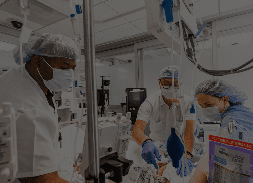 Video poster: Three Cleveland Clinic surgical caregivers performing a patient surgery in an operating room.