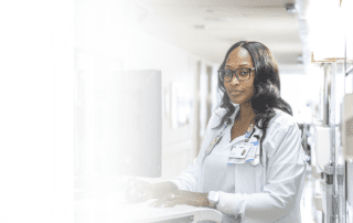 Cleveland Clinic nurse working at a computer workstation in a hospital hallway